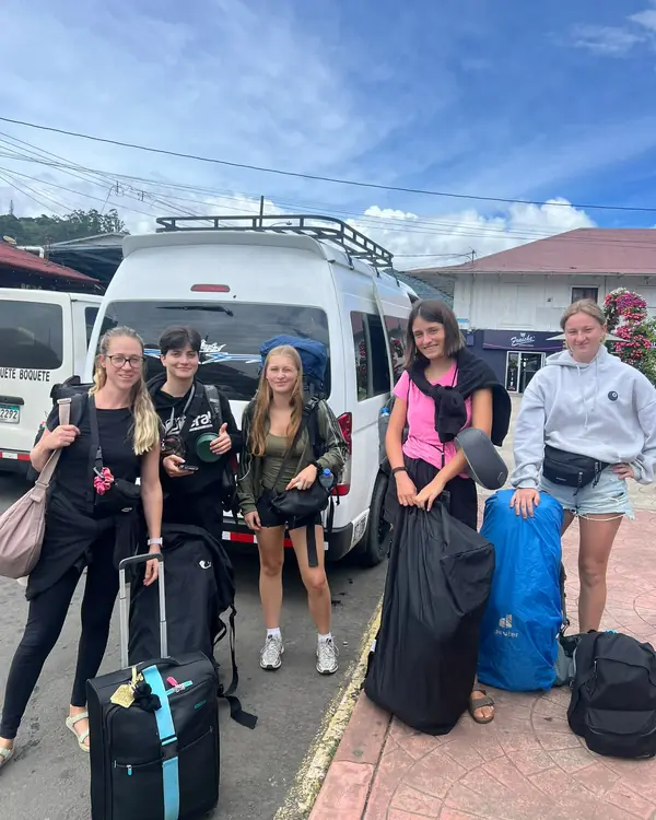 Travelers next to our van before a transfer