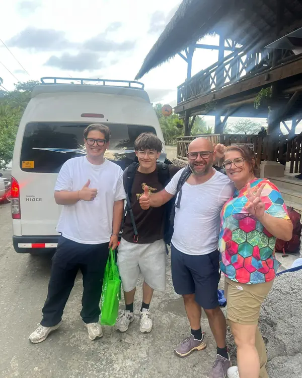 Travelers next to our van before a transfer